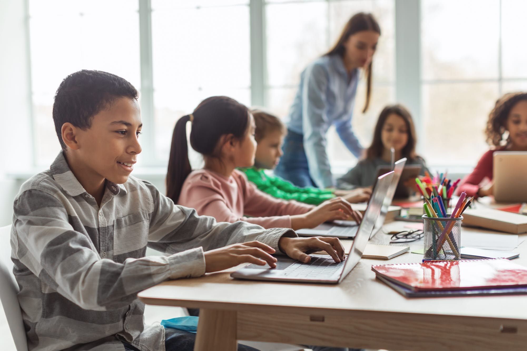 Children in a classroom using laptop computers