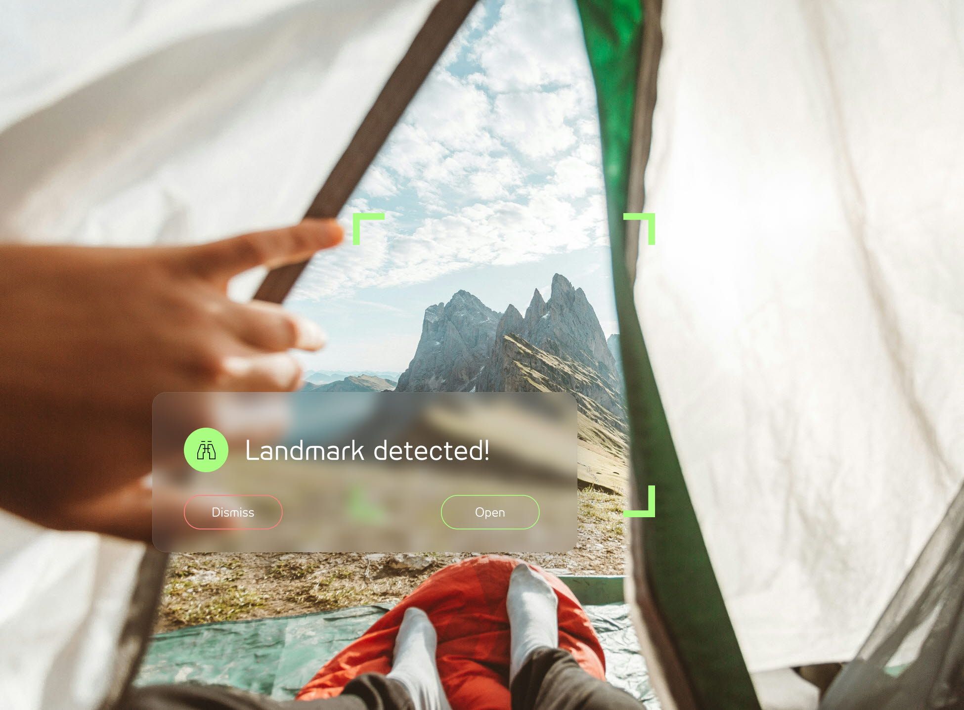 Person looking at a mountain from a tent